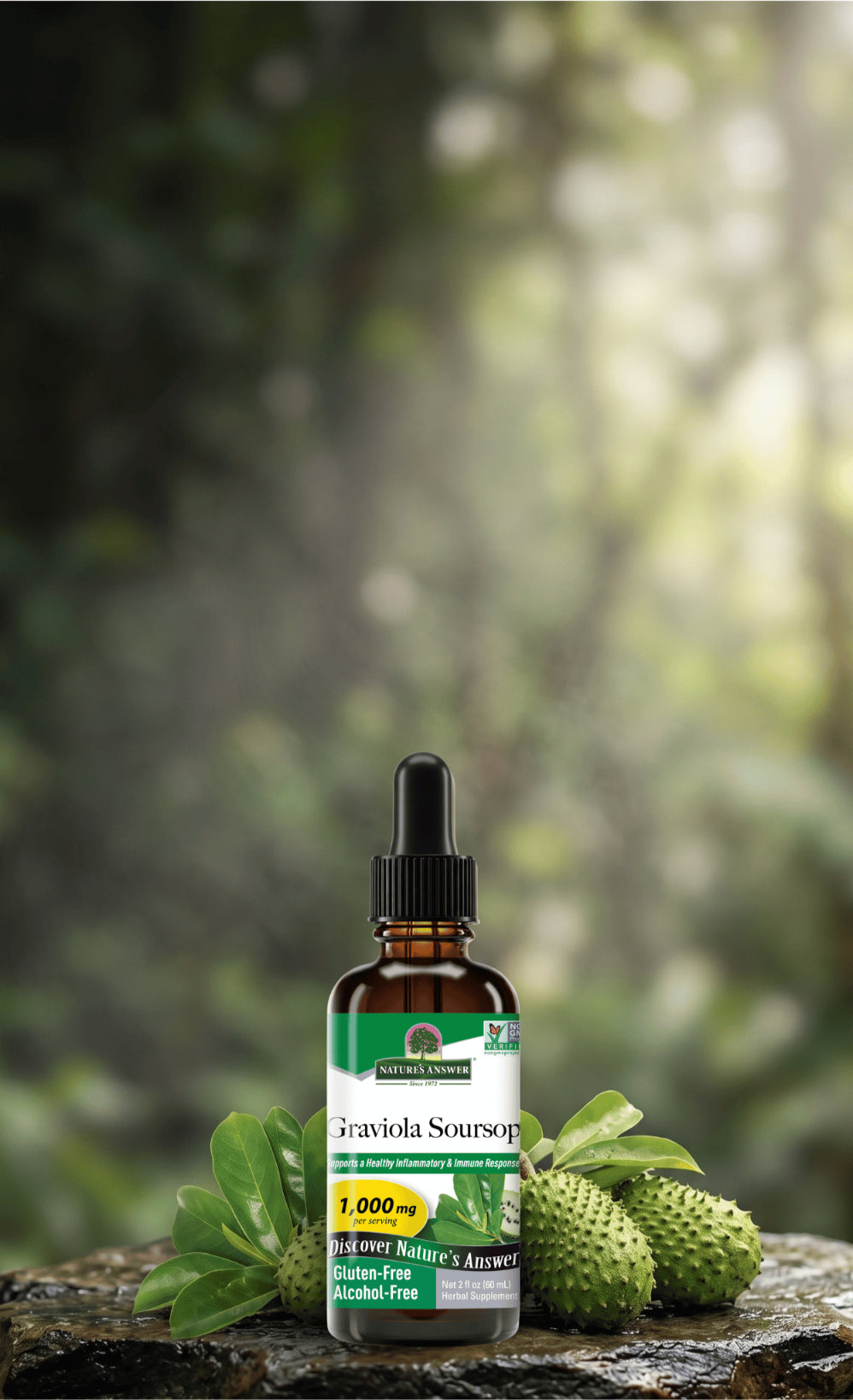 A bottle of Graviola Soursop herbal extract with a black dropper cap, displayed on a rustic log with fresh green leaves and fruit against a blurred forest background.
