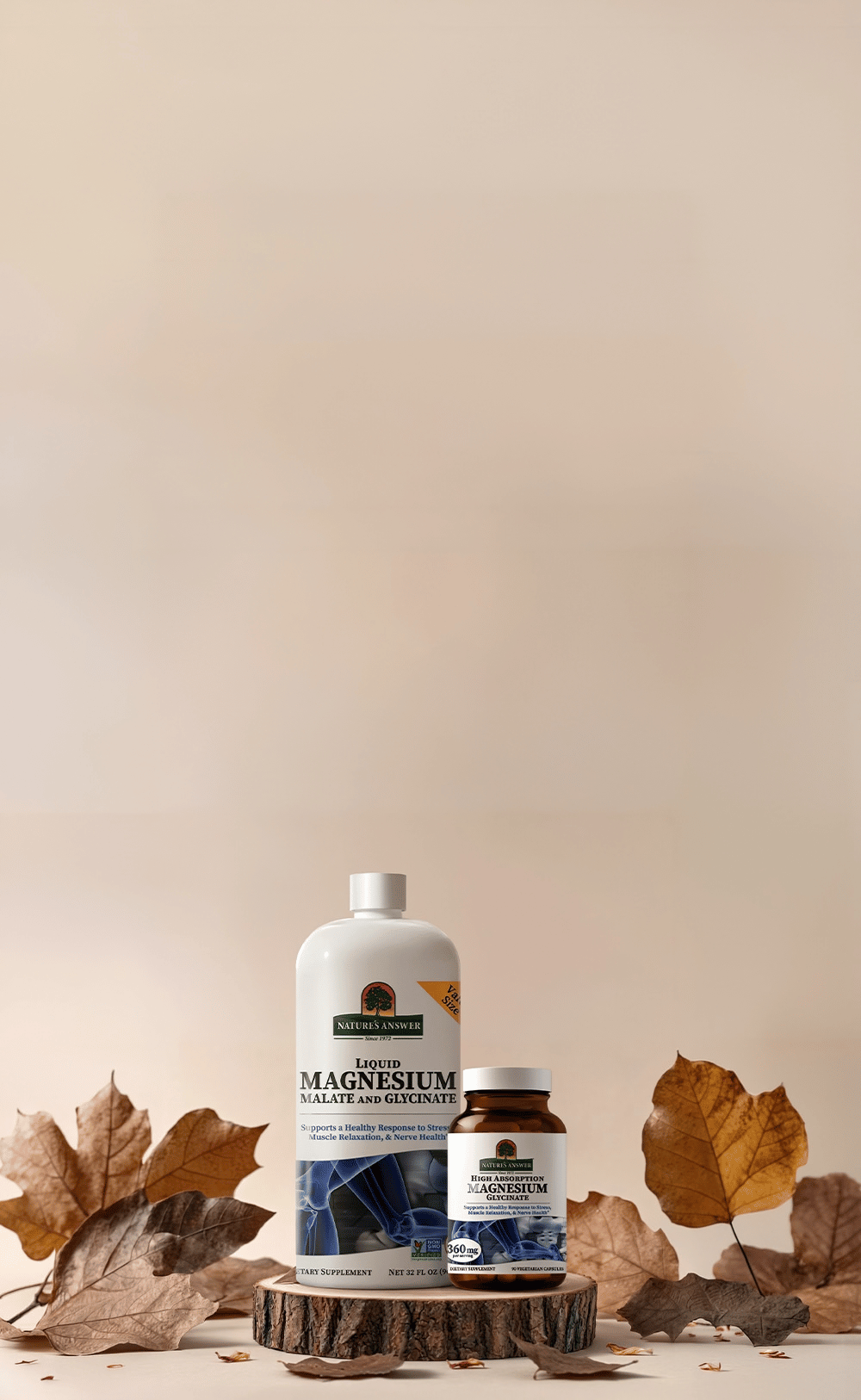 Two bottles of Magnesium supplement from nature's answer, one large white bottle and one smaller amber bottle, displayed on a wooden slice pedestal with scattered dried autumn leaves against a warm beige background.